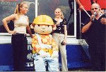 The girls from Suspicion strike a pose with Bob the Builder at Truckfest 2001 at the Bath and West Showground.