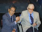 Kaname Harada and John Sykes showing that they are now friends, sixty years after their initial encounter - a dog fight in World War Two.

Fleet Air Arm Museum, Yeovilton, 07-Aug-2001